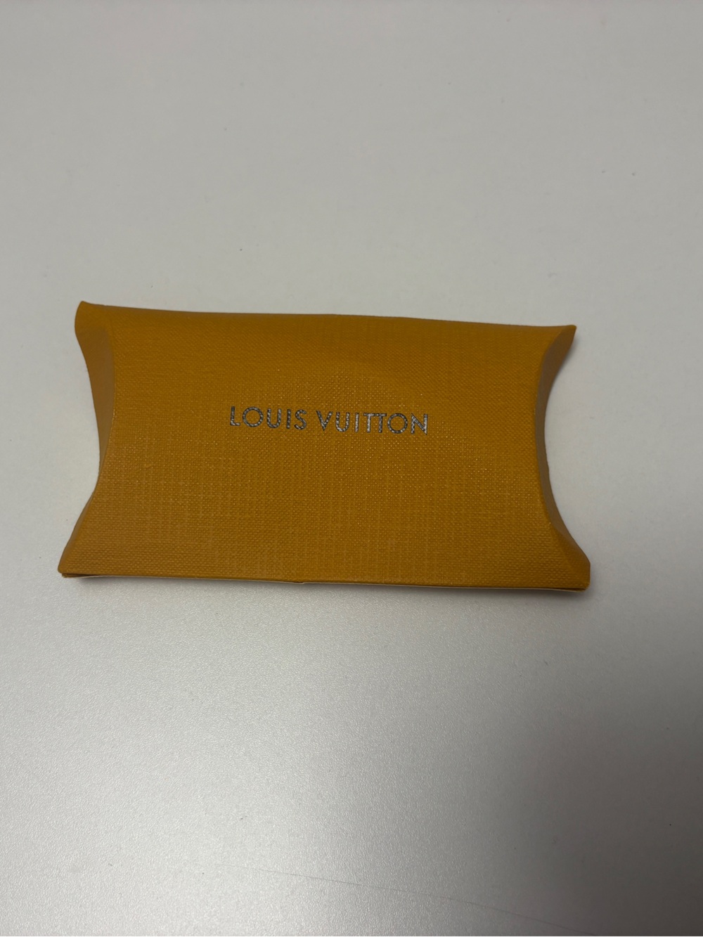 Louis Vuitton shoelace sleeve and white original shoe laces. (New)